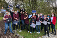 Frauen strecken Arme in die Luft und halten Filztaschen in Händen