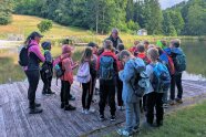 Kinder stehen auf einem Steg vor dem Saldenburger Weiher und werden begrüßt